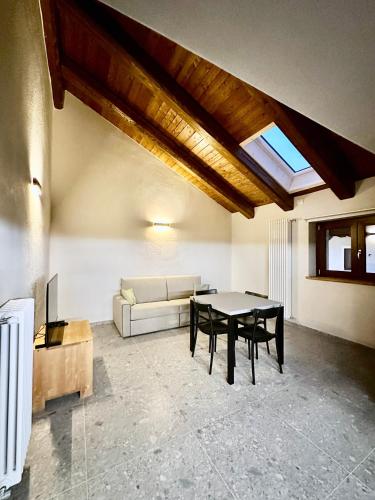 a living room with a table and a couch at Case Verdi in Bardonecchia