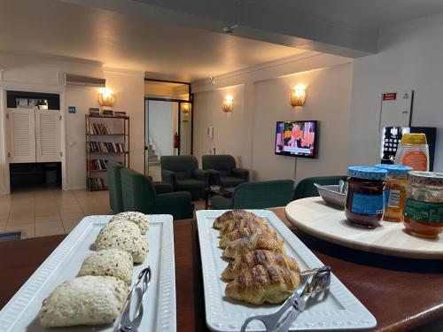 a table with two trays of pastries on it at Hotel Ilha in Angra do Heroísmo