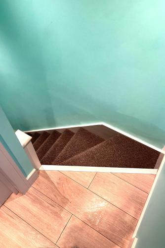 a corner of a room with a wooden floor at Letzi Ensuite, 15 Min to Heathrow, Fast WiFi in Hayes