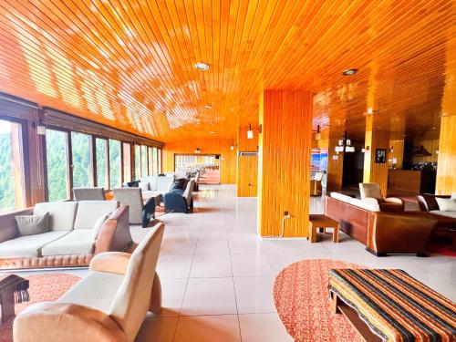 a lobby with couches and chairs in a building at Lahza Hills Resort in Çaykara