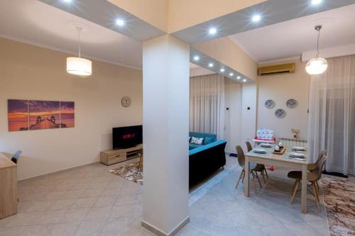 a living room with a table and a blue couch at Anna's House in Komotini