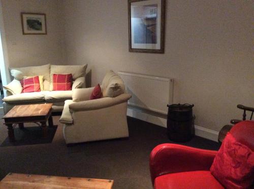 a living room with two couches and a coffee table at Glencarse Hotel in Glencarse