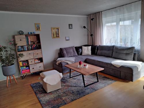 a living room with a couch and a coffee table at ciao-aschau FeWo Lexa in Aschau