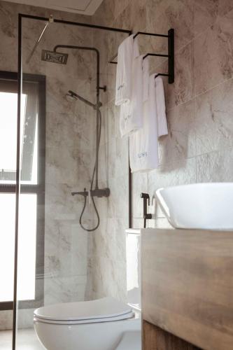 a bathroom with a toilet and a sink at Saphir Boutique Hotel in Kigali