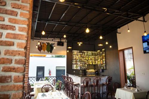 a restaurant with tables and chairs and a bar at Saphir Boutique Hotel in Kigali