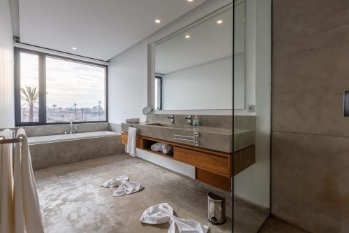 a bathroom with a sink and a large mirror at VILLA 103 - Luxury Getaway - Private Jacuzzi in Marrakech