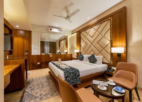 une chambre d'hôtel avec un lit et un salon dans l'établissement Hotel Town Palace-Best Business Hotel in Bijapur, à Bijapur