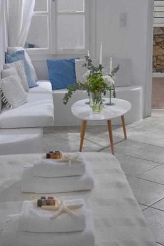 a living room with a couch and a table with towels at Luxurious Villa Ostria in Elia Beach