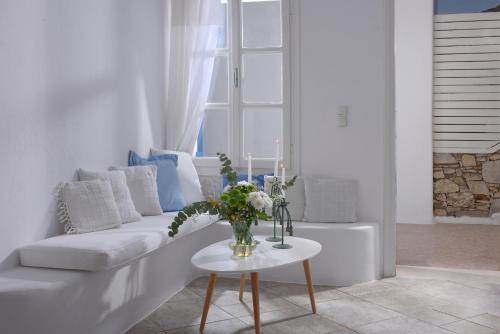a living room with a white couch and a table at Luxurious Villa Ostria in Elia Beach