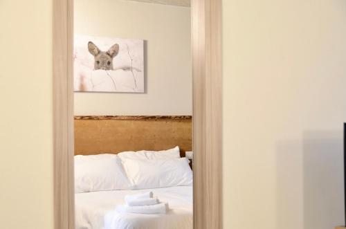 a mirror reflection of a bed in a bedroom at Case Verdi in Bardonecchia