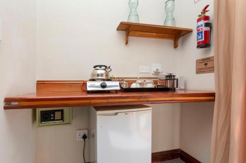 a kitchen with a counter with a tea kettle on it at Teak Place Guest Rooms in Krugersdorp