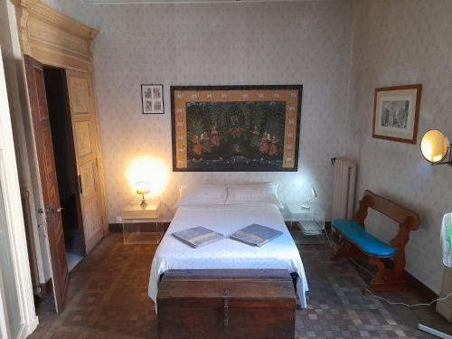 a bedroom with a bed and a painting on the wall at Le Stanze del Notaio in Genova