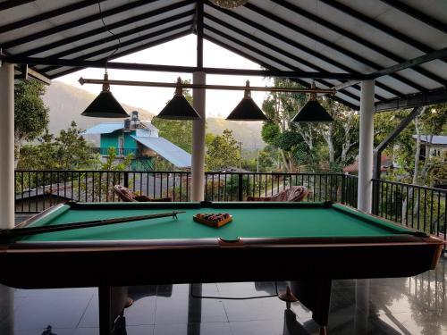 a pool table in front of a house at Ella Forest Paradise Hotel in Ella