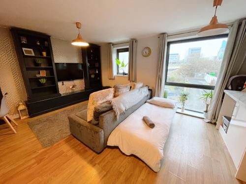 a living room with a couch and a large window at Newcastle River View Quayside Apartment - Private Parking - Sleeps 7 - City Centre Walking Distance in Gateshead