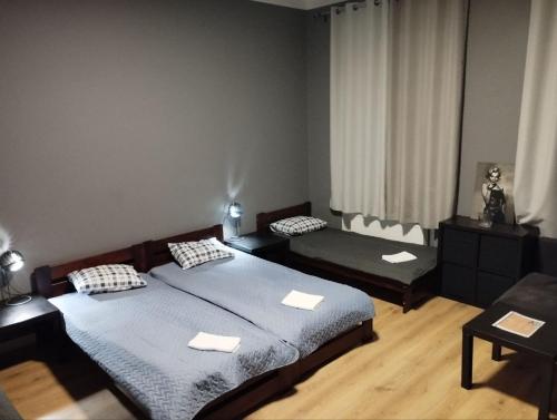 a bedroom with two beds and a couch at Centro Hostel in Vilnius