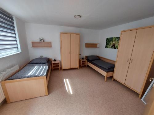 a room with two beds and two cabinets in it at Gästewohnung Vesta in Bad Dürrenberg