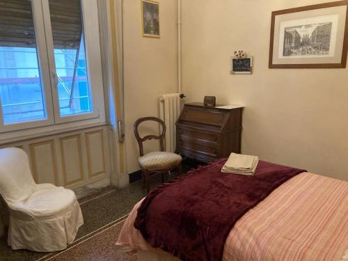 a bedroom with a bed and a desk and a chair at Le Stanze del Notaio in Genova