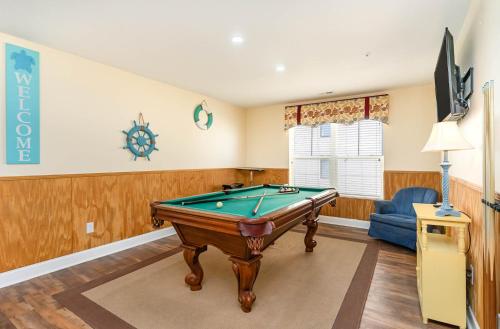 a living room with a pool table and a couch at Spacious Penthouse Ocean Front 7 BR Condo - Ambassador Villas Unit 401 in Myrtle Beach