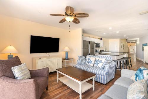 a living room with a couch and chairs and a tv at Spacious Penthouse Ocean Front 7 BR Condo - Ambassador Villas Unit 401 in Myrtle Beach