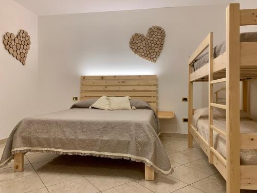 a bedroom with a bed with hearts on the wall at Agriturismo Nonno Mario in Fossone dʼAdige
