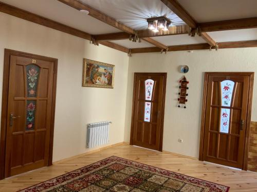 an empty room with two doors and a rug at Гостьовий двір РіОНІ in Truskavets