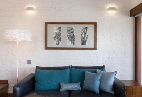 a living room with a couch and a picture on the wall at Jetwing Saman Villas, A Luxury Reserve - Adults Only in Bentota