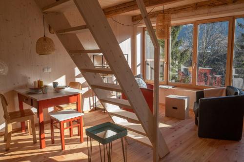 a wooden spiral staircase in a room with a table at Servus Almtal in Scharnstein
