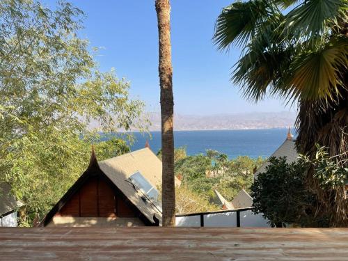 a house with a view of the ocean at Orchid Eilat Hotel in Eilat
