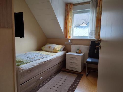 a small bedroom with a bed and a window at Gästehaus im Alten Fährhaus in Cochem