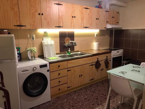 a kitchen with a washing machine and a sink at Sea Sunset Appartment in Nea Iraklia