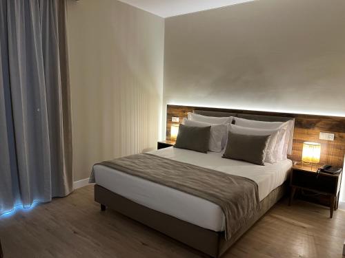 a bedroom with a large bed with white sheets and pillows at Madeira Bright Star by Petit Hotels in Funchal