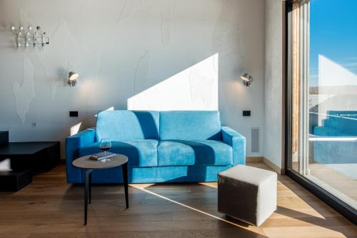 a blue couch in a living room with a table at VINEHO in Barolo