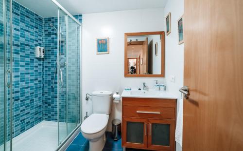 a bathroom with a toilet and a sink and a shower at La Tarasca Apartamento turístico in Zamora