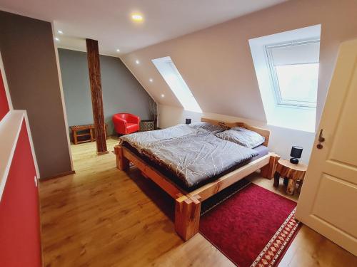 a bedroom with a bed and a red rug at HarzRitter Domizil in Cattenstedt