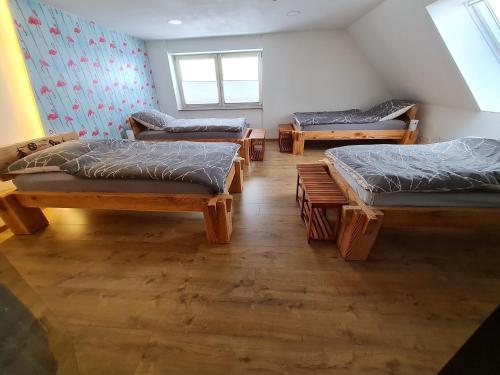 a room with three beds and a window at HarzRitter Domizil in Cattenstedt