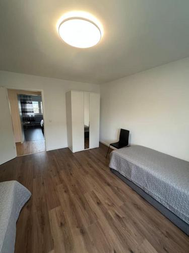 an empty room with two beds and a lamp at Familienwohnung neben dem See,Messe und Europapark in Offenburg