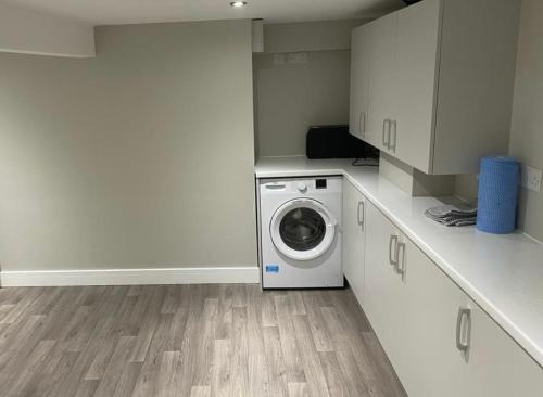 a laundry room with a washing machine in it at Apartment in Uppermill in Saddleworth