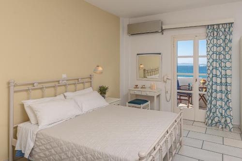 a bedroom with a bed and a view of the ocean at Orkos View in Mikri Vigla