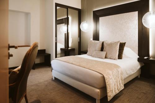a bedroom with a large bed with a large mirror at Domaine d'En Fargou in Saint-Sulpice