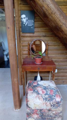 a small wooden room with a table and a mirror at ENTRE VIÑAS in Ciudad Lujan de Cuyo