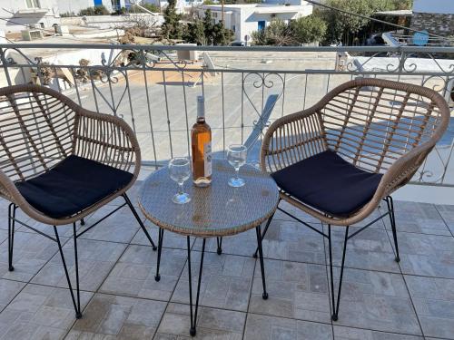 a table with two chairs and a bottle of wine at Hotel Chrisoula in Antiparos Town