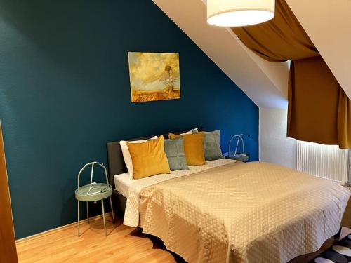 a bedroom with a bed and a blue wall at Cozy flat in the heart of Buda in Budapest
