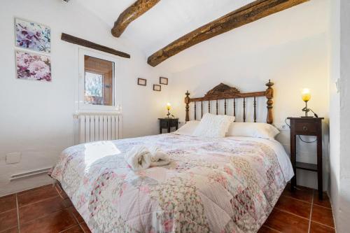 a bedroom with a bed with a dog laying on it at Teresina in Perelló