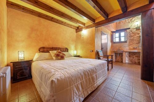 a bedroom with a bed and a table and a window at Lo paller in Perelló