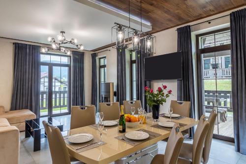 a dining room with a table and chairs at Greitser Elit Chalet in Bukovel
