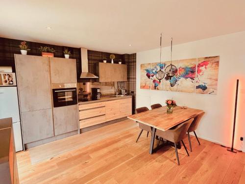 a kitchen with a wooden table and a refrigerator at Starnberger See in Feldafing