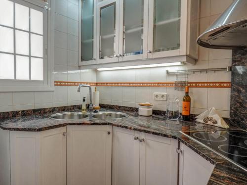 a kitchen with two sinks and a counter top at Montroig Zen Penthouse by Hello Homes Sitges in Sitges