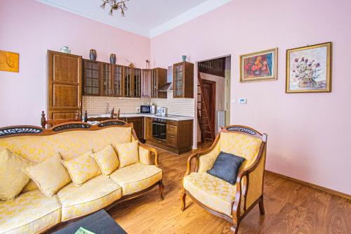 a living room with a couch and two chairs at Astronomical Clock Suite by Ruterra in Prague