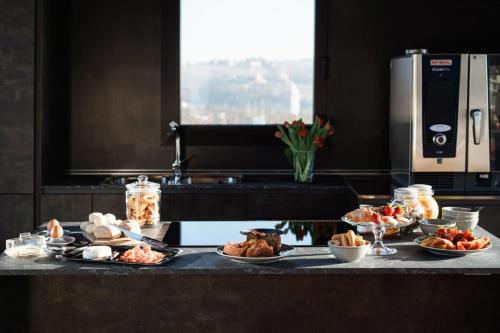 a counter with many plates of food on it at VINEHO in Barolo