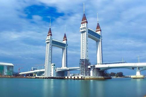 a large bridge with two towers over the water at RJ Prima (UMT, UniSZA, Spacious, Beach + Netflix) in Kuala Terengganu